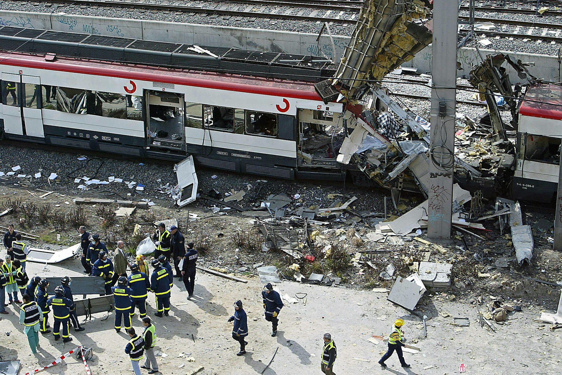 Bodies of victims are evacuated from a partially destroyed train.