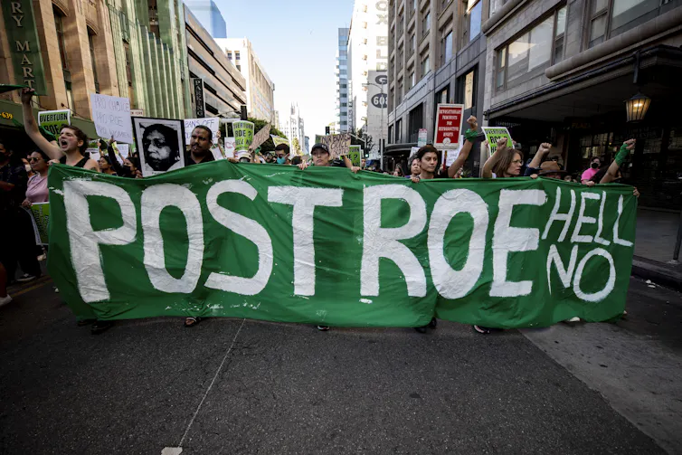 Pro-choice demonstrators protest in Los Angeles carrying a banner reading Post Roe Hell No