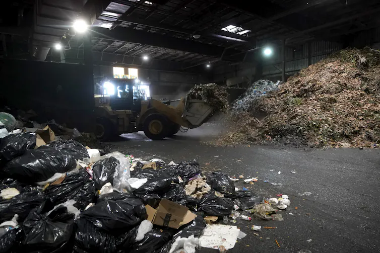 Piles of waste are seen in a warehouse.