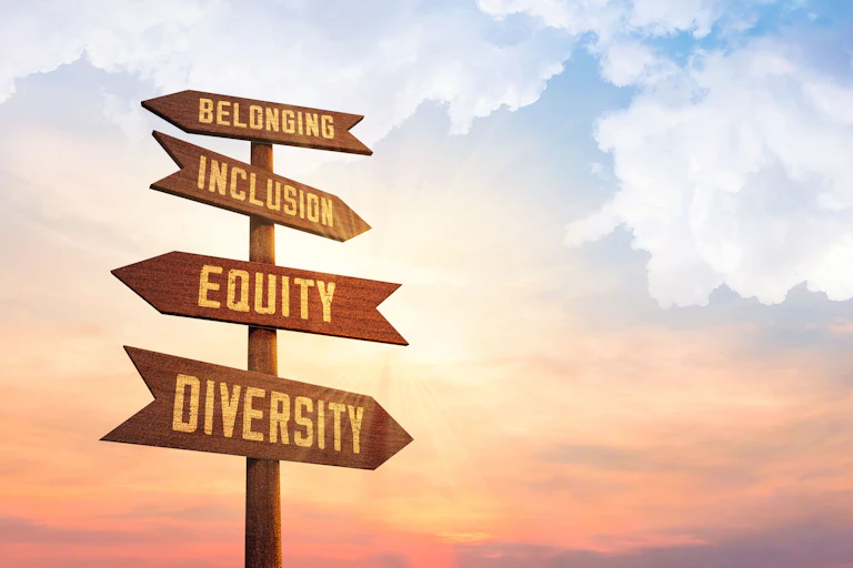 A pathfinding sign points to "belonging," "inclusion," "equity" and "diversity."