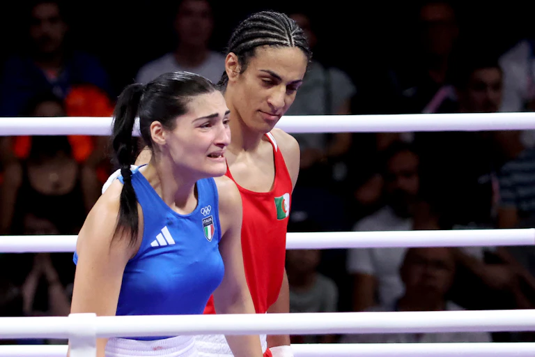 Angela Carini (L) abandons her bout against Imane Khelif