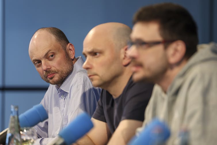 Vladimir Kara-Murza, Andrei Pivovarov, and Ilya Yashin sit with microphones talking with the press.