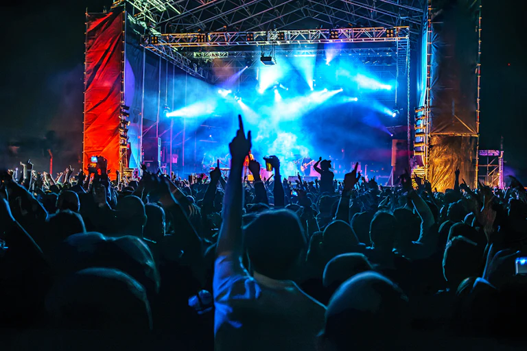 A crowd enjoys a band at a festival or concert.