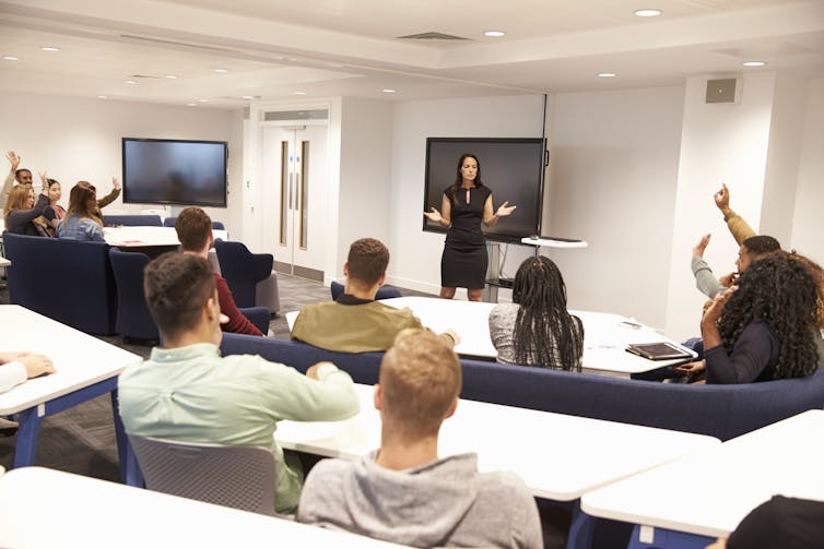 University students in a room with a lecturer.