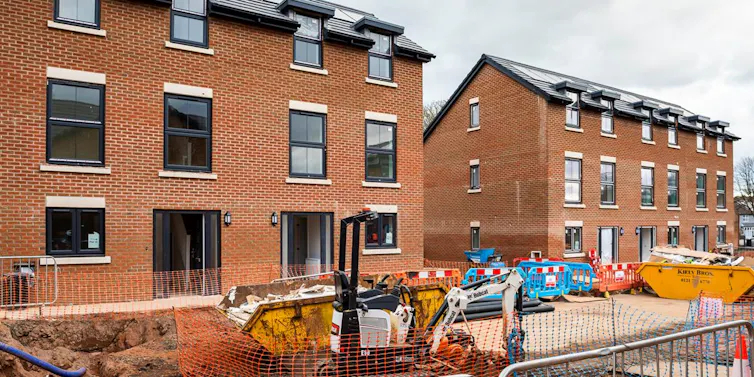 red brick homes with building site machinery in front