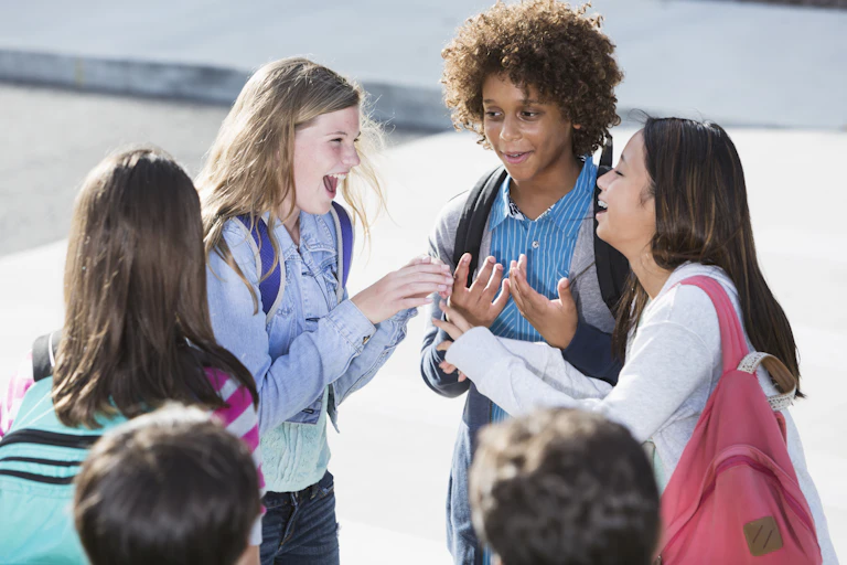 A group of children talking and laughing.