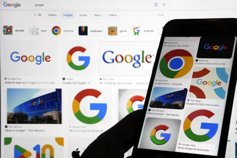Various Google logos displayed on a phone and computer screen