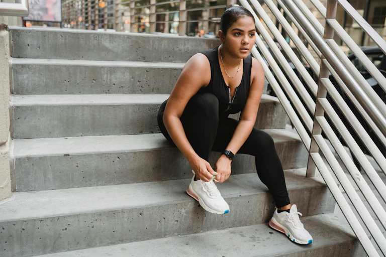 Woman ties sneaker
