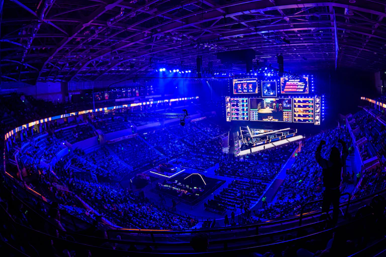 Spectators cheer on video game players in a stadium