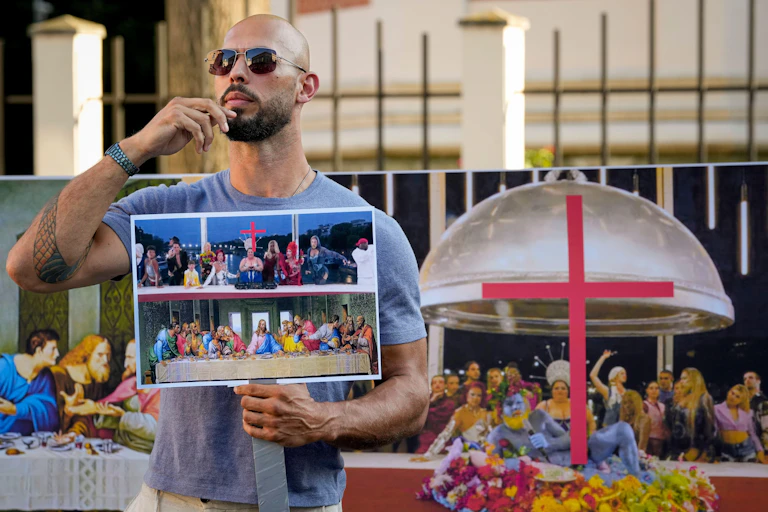 Man holding a placard with the Last Supper painting