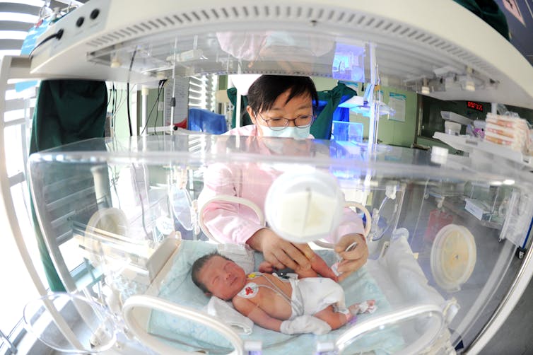 Medical worker takes care of newborn baby in hospital.