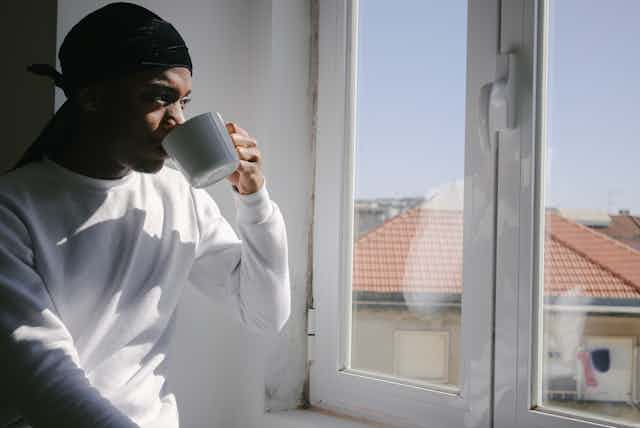 Man looks out his window