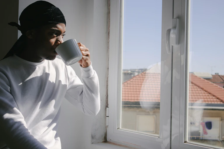 Man looks out his window