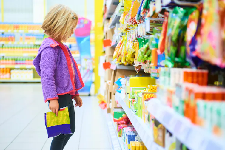 Child looks at lollies.