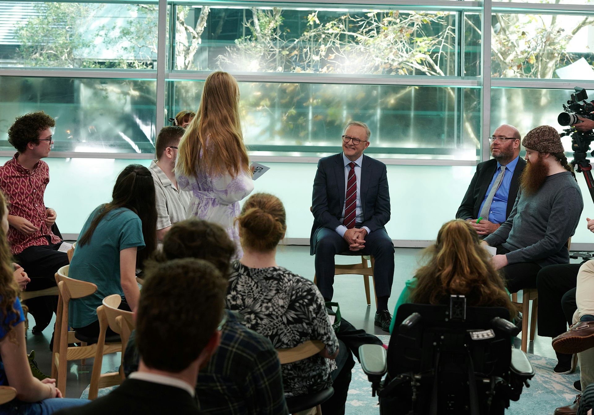 group of people standing and seated in circle talking