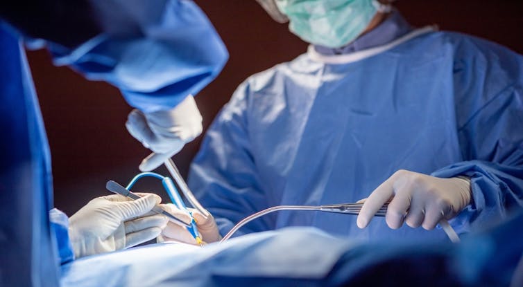 Surgeons operating in theatre