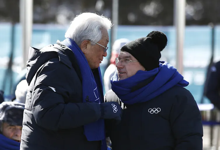 Chang Ung speaking with the IOC's president, Thomas Bach.