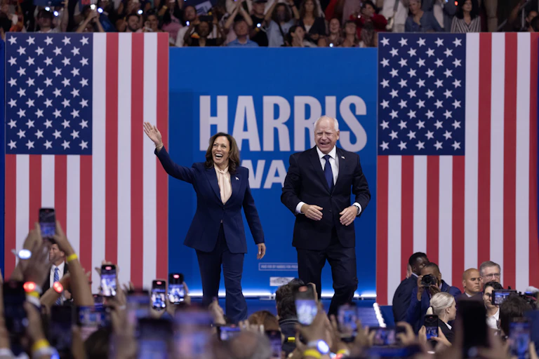 Kamala Harris with vice-presidential candidate Tim Walz on stage at a rally in Philadelphia August 6 2024.