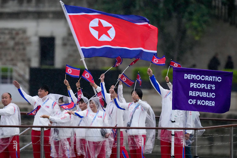 The North Korean Olympic delegation waving their country's flag.