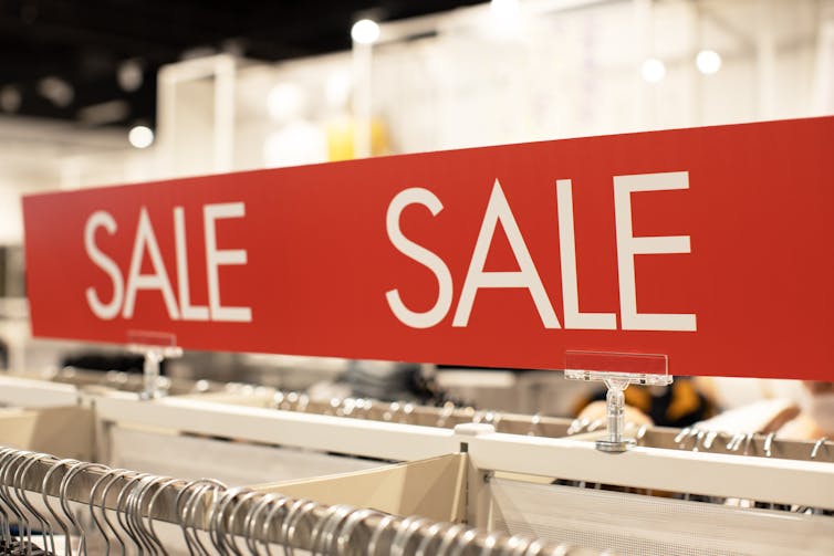 A sales rack in a clothes shop.