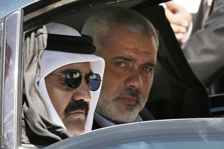 A man in traditional Gulf Arab dress and another manwith a beard are seen in the back of a car.