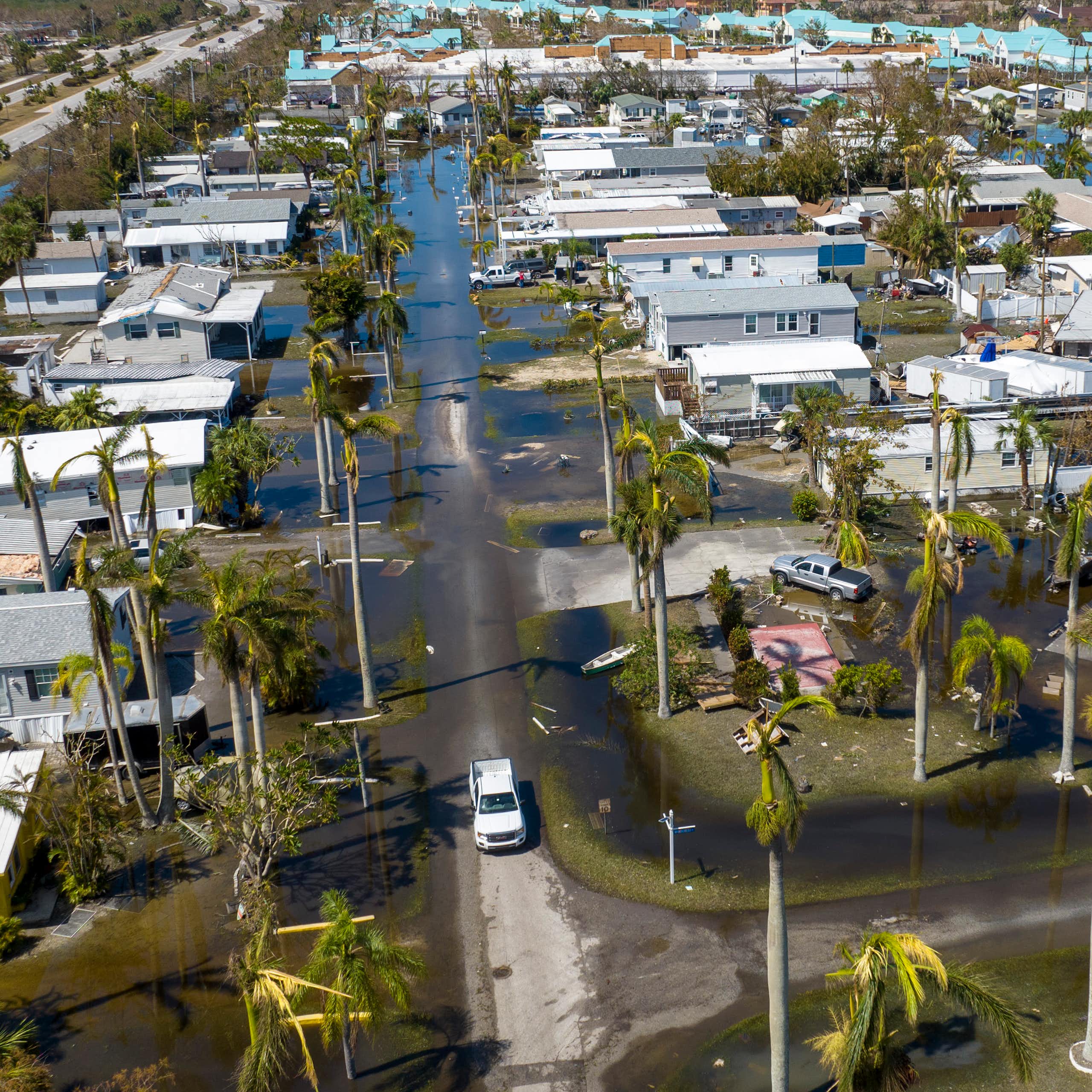 A mobile tightly packed mobile home communitiy filled with water, seen from the air after Hurricane Ian.