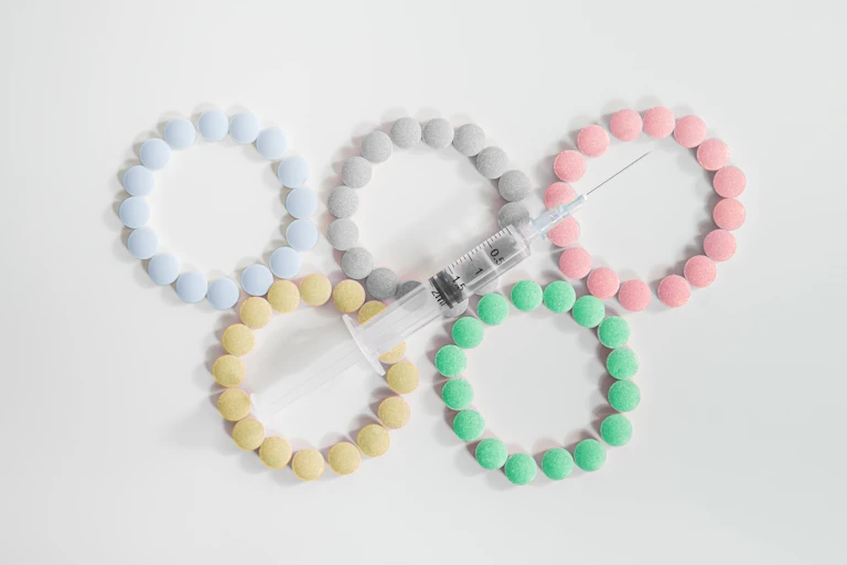 The Olympic rings made of pills and a syringe