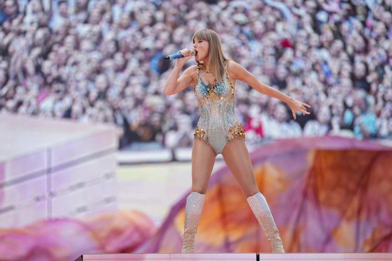 A woman in a sparkly bodysuit sings on a stage