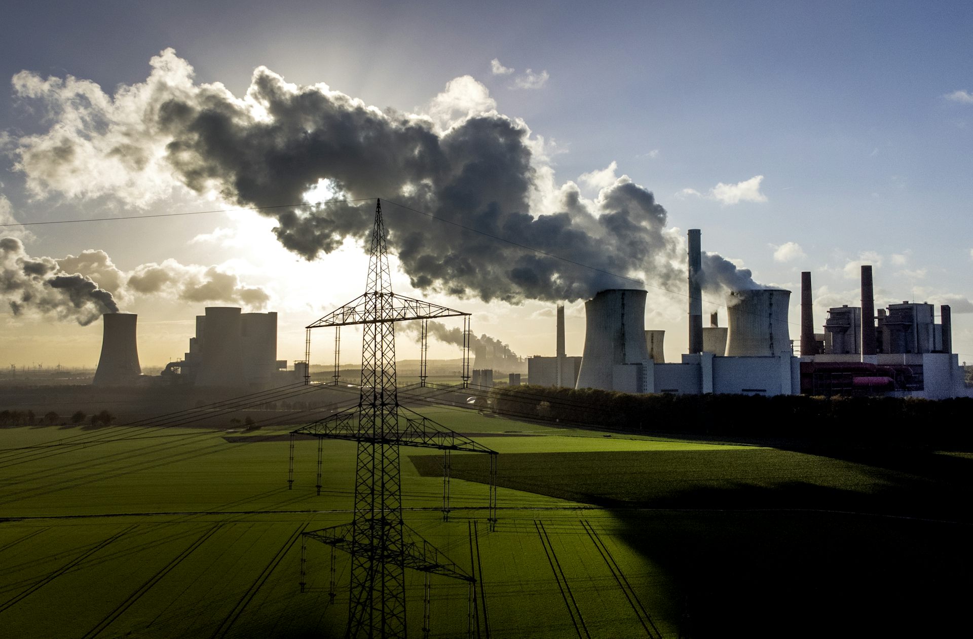 steam billows from industrial plant