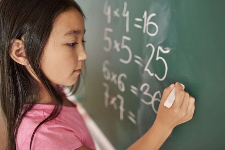girl trying to solve mathematical equation
