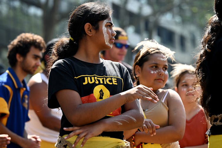 Girl wearing a t-shirt saying 'justice'