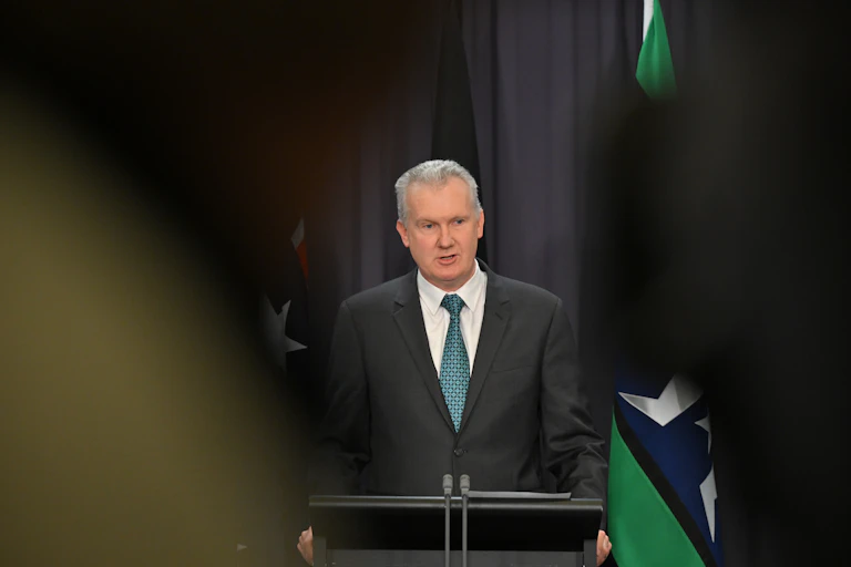 A man stands at a lectern and talks