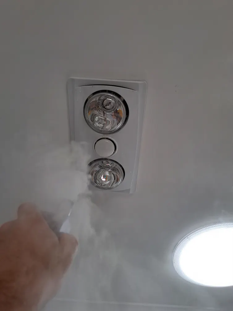 Smoke testing of a combination fan light and heater for air leaks