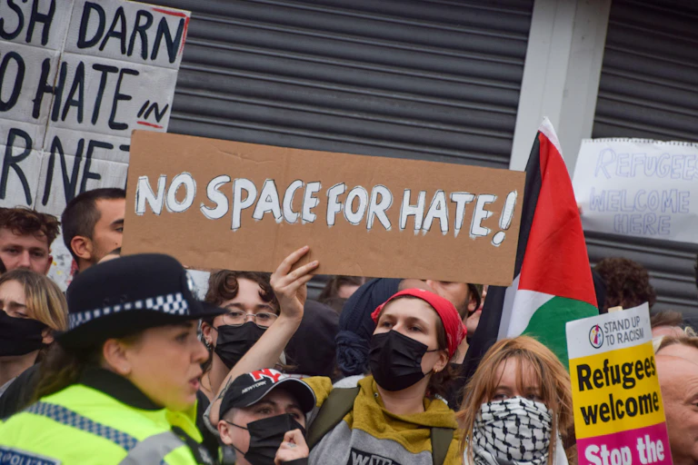 Protester holds a home-made sign reading "No space for hate!"