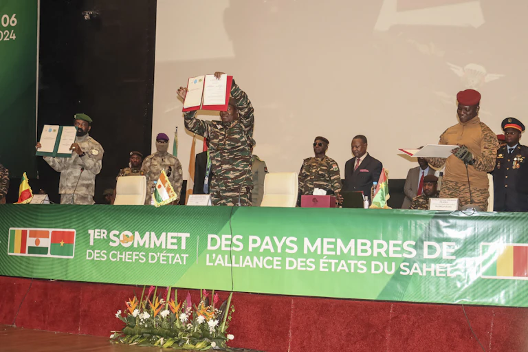 Men in military uniform displaying a document to their audience