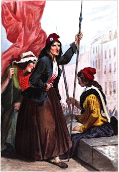 A person with pointed spear seen in a red cap.