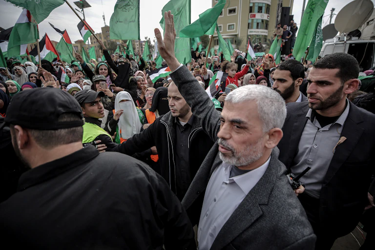 Yahya Sinwar waving to supporters during a Hamas rally