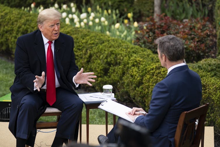 Donald Trump filming a Fox News interview during the COVID pandemic.