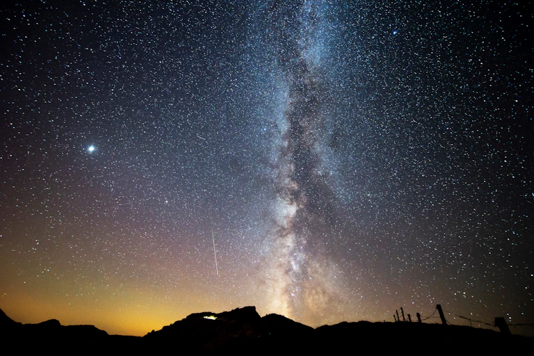 Perseids are seen next to Milky Way during the annual Perseid meteor shower in northern Spain.