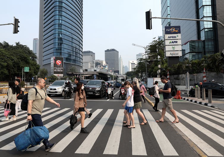 people cross road in big city