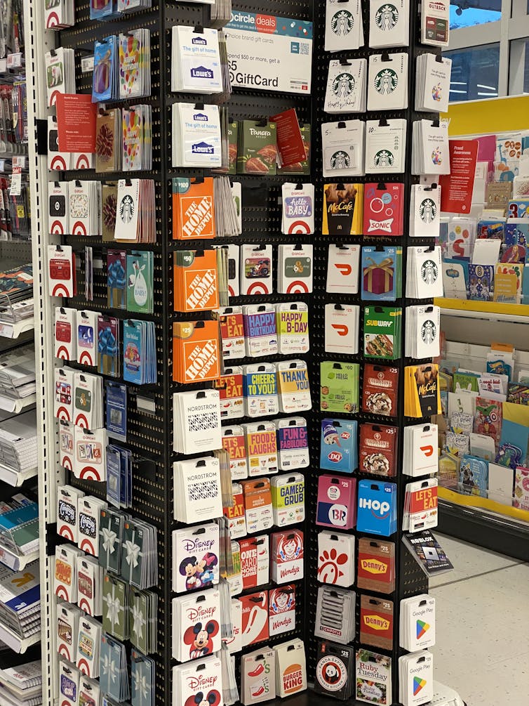 A rack of several dozen gift cards of different types and colors
