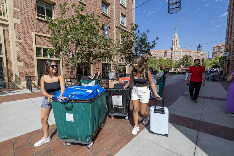 Students toting luggage move into dorms at the University of Southern California in a photo taken on Aug. 15, 2023.