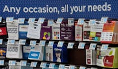 A portion of a drugstore gift card rack showing the tagline