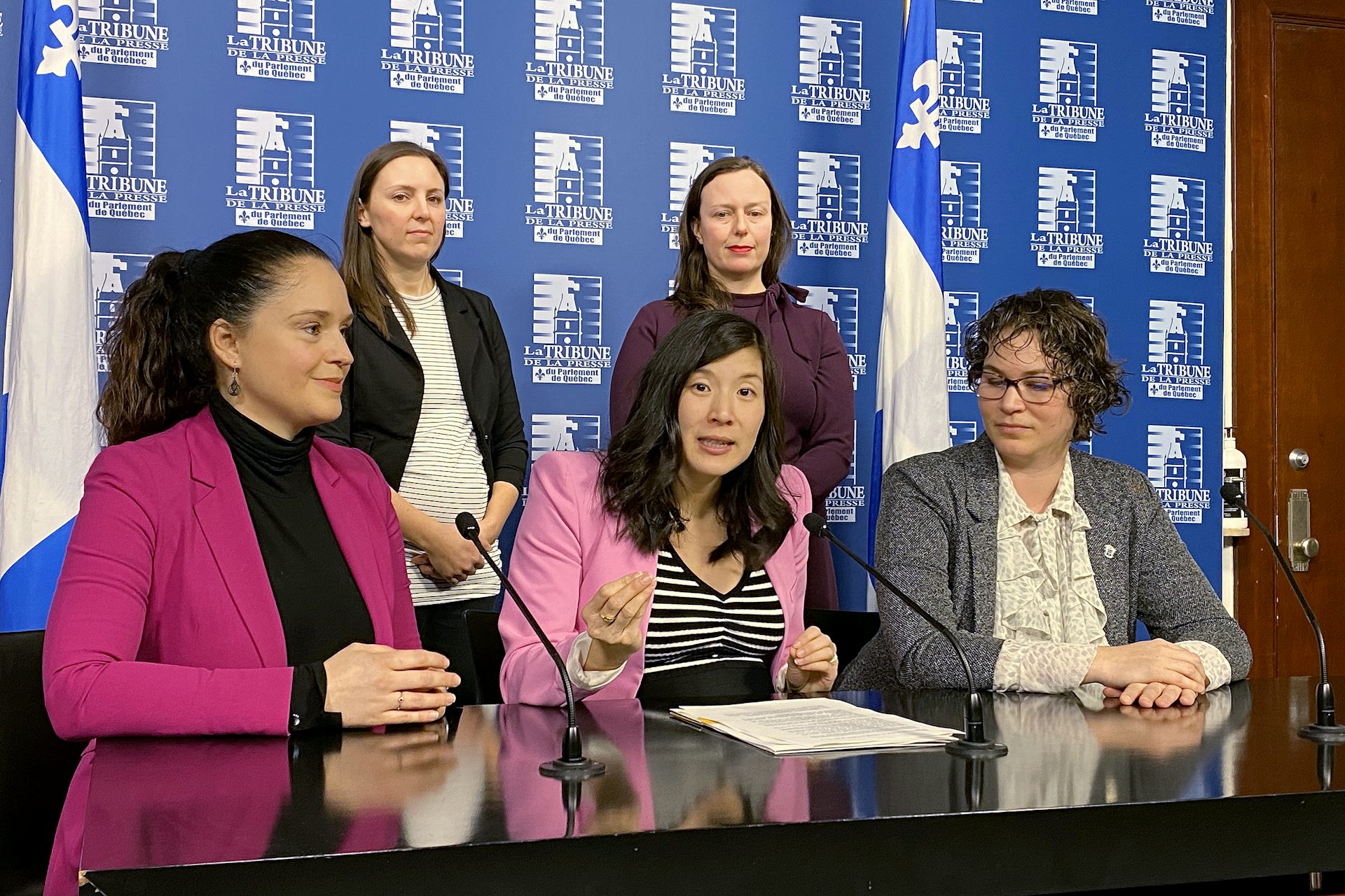 Five women at a news conference.