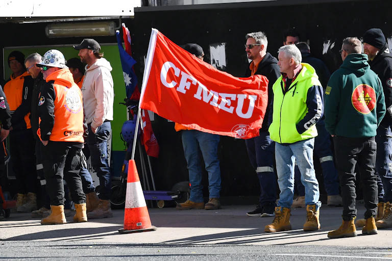 Group of men standing outside a building site