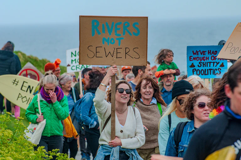 People walking with placards protesting against river pollution