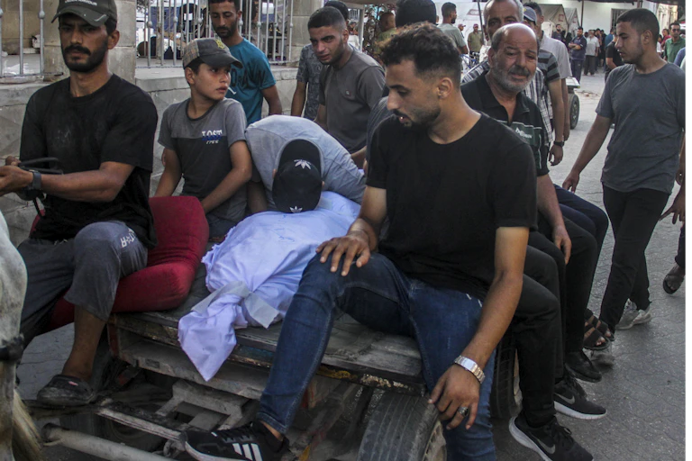 Palestinians carry a relative's body on a cart following an Israeli strike on the Al-Taba'een school in the Daraj Tuffah neighborhood of Gaza, 10 August 2024.