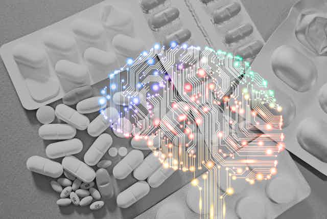 A diverse array of different-sized white pills lie on a gray background with a brain concept in the foreground.