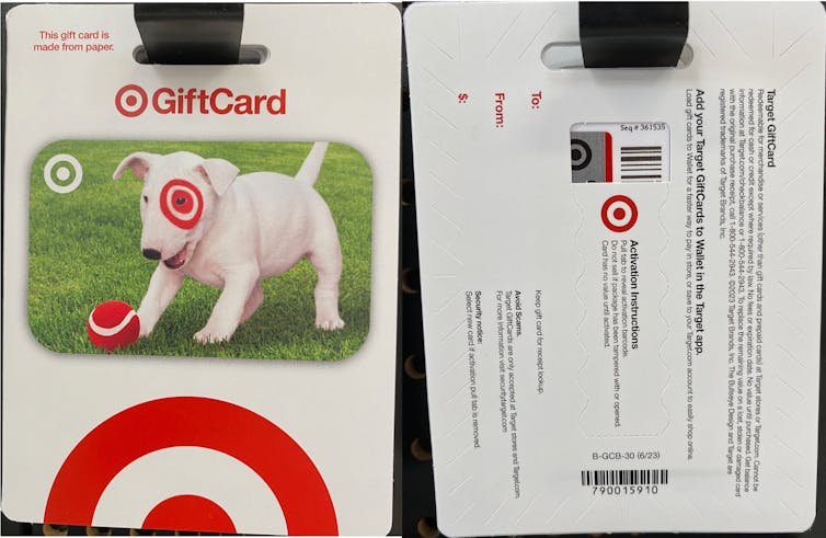 Gift cards hang side by side; one shows the front with a picture of a dog and a Target logo, the other shows the back