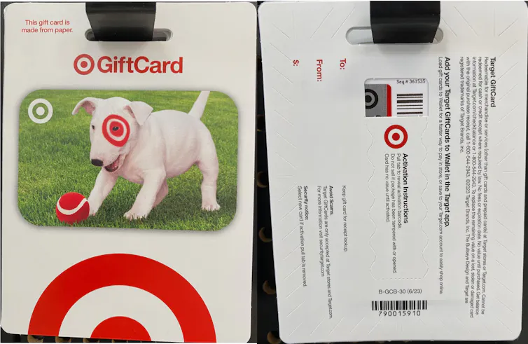 Gift cards hang side by side; one shows the front with a picture of a dog and a Target logo, the other shows the back